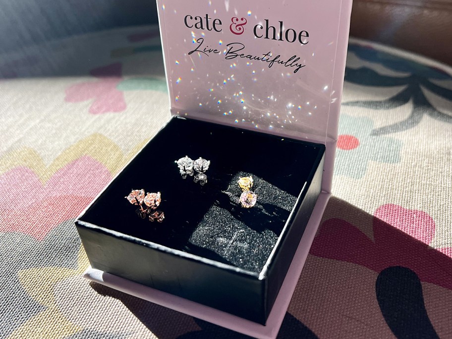 three pairs of earrings in gift box sparkling in sun