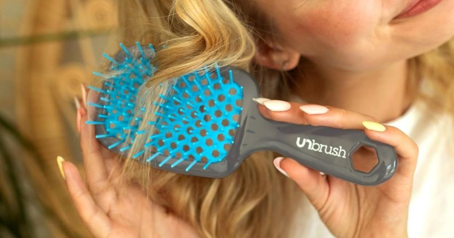 woman brushing her hair with the FHI Heat UNbrush Detangling Brush