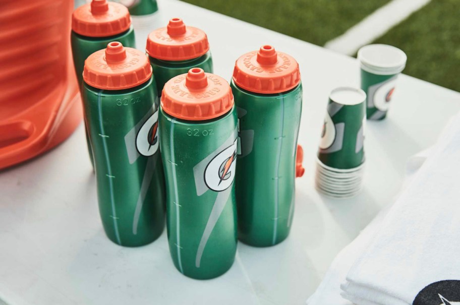 gatorade squeeze bottles on bench outside