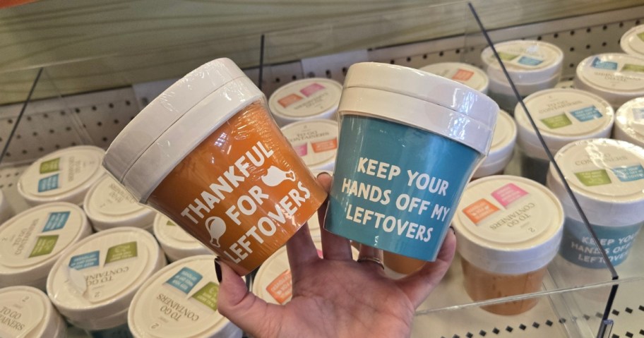 hand holding 2 sets of Thanksgiving themed to go containers with funny quotes on them