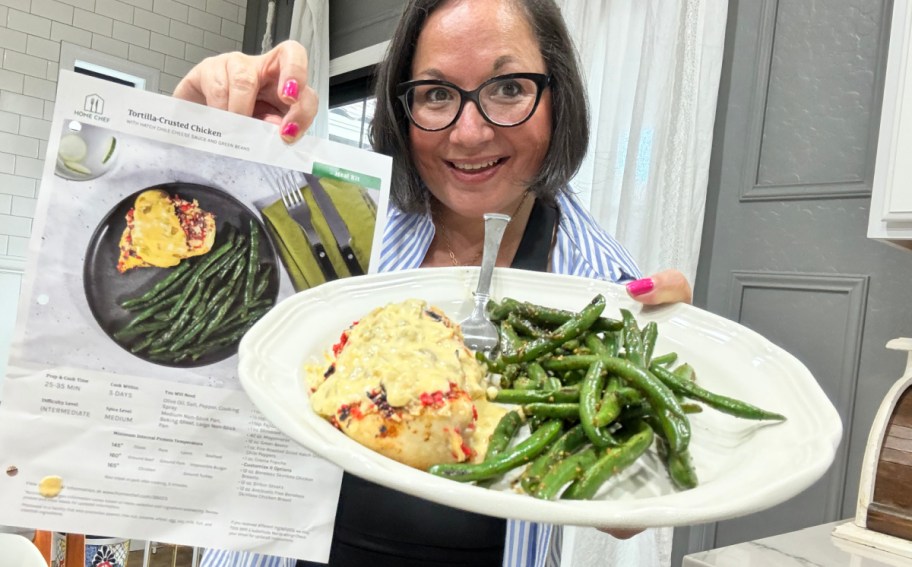 woman holding up Home Chef recipe card and meal 