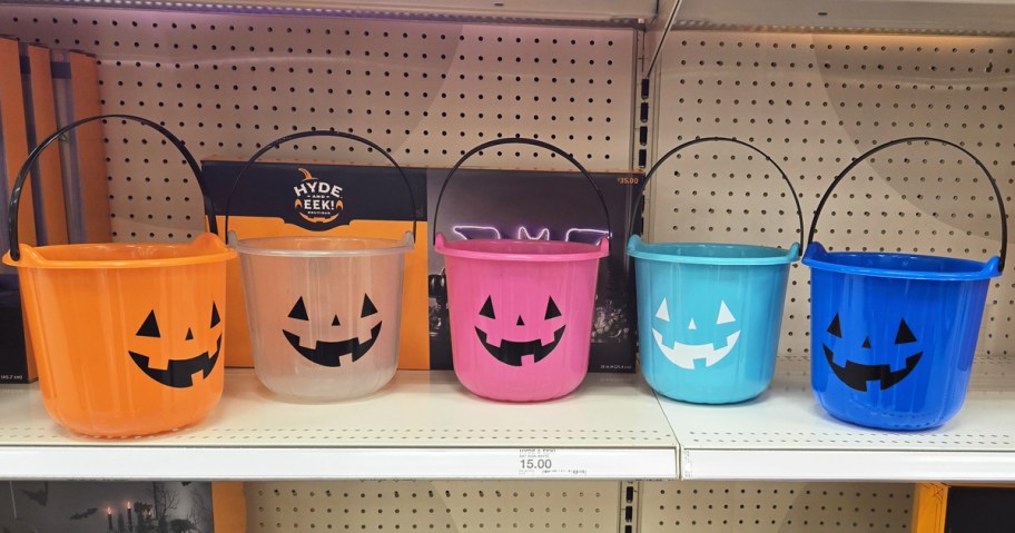 colorful pumpkin trick or treat buckets on store shelf