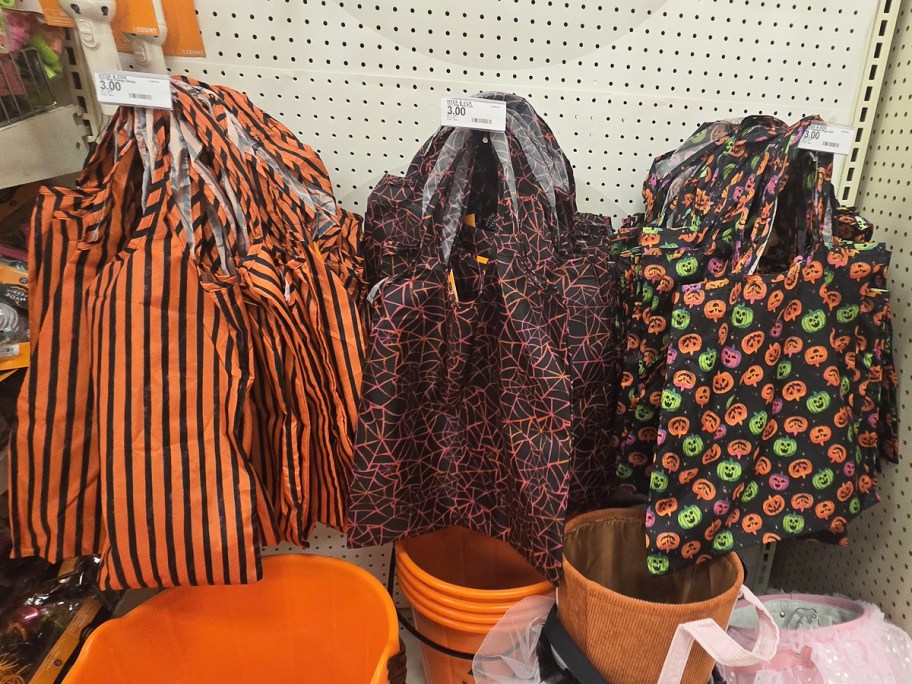 reusable halloween tote bags hanging from store display