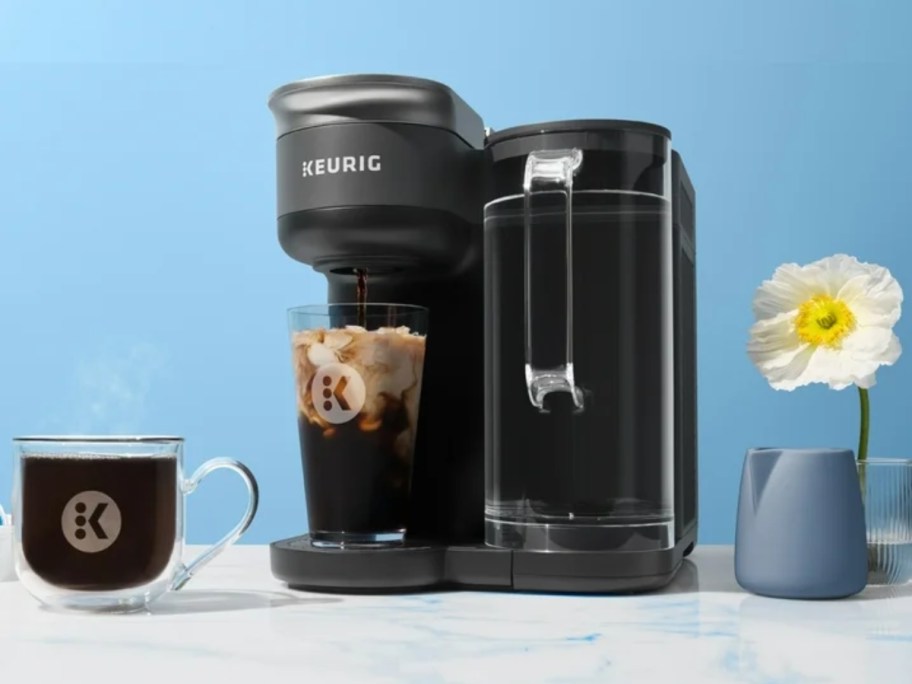 Keurig K-Brew + Chill Coffee Maker making iced coffee on countertop with blue background
