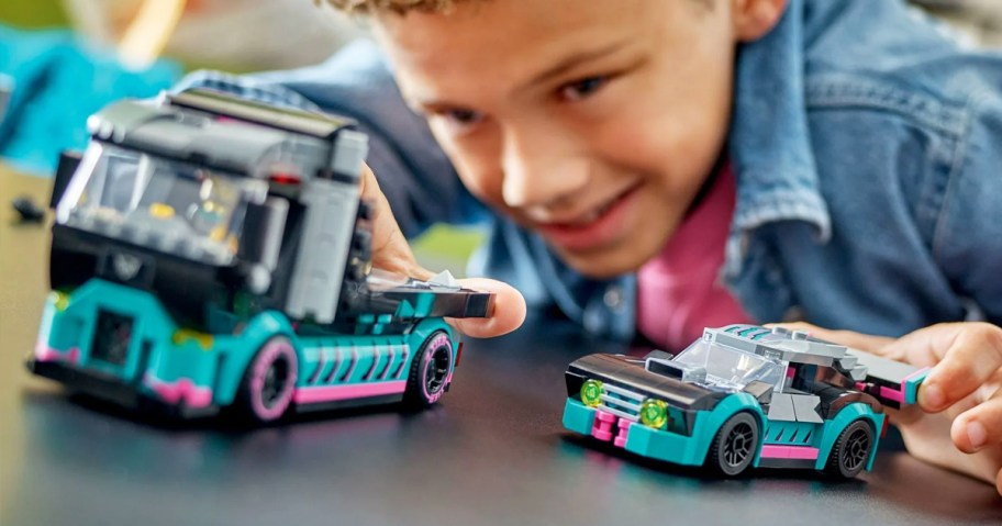 boy playing with LEGO City Race Car and Car Carrier Truck set