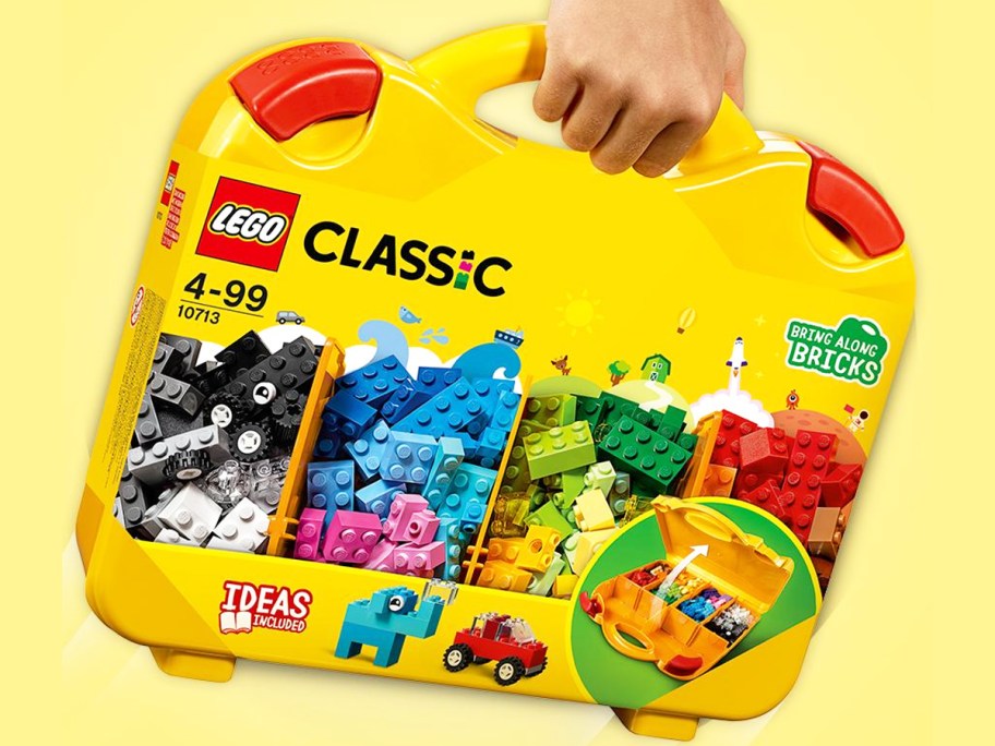 hand holding a yellow LEGO Classic Creative Suitcase