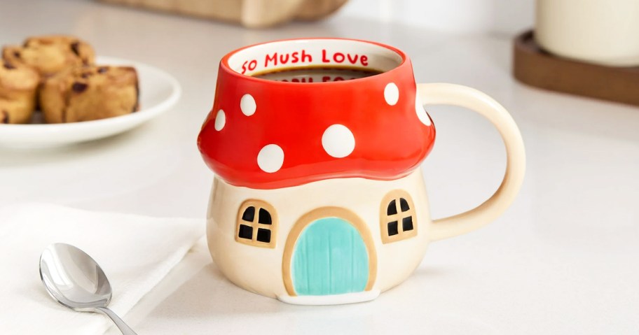 mushroom house coffee mug that says "so mush love"