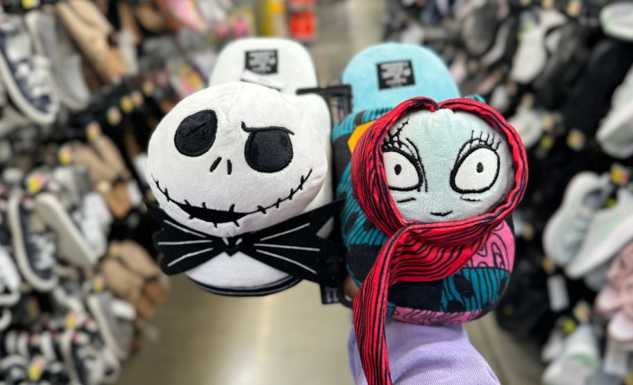 a womans hand shown holding a pair of nightmare before Christmas womens slippers