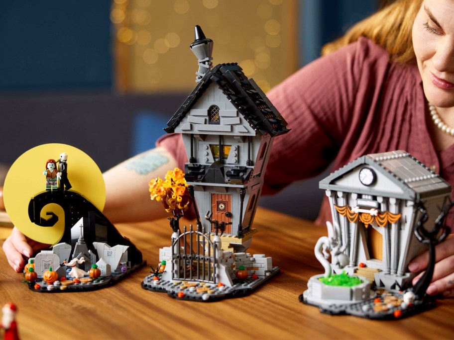woman looking at Nightmare Before Christmas LEGO Set