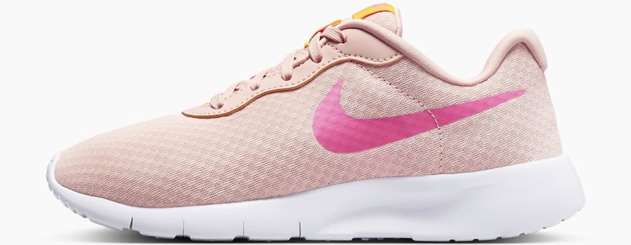 light pink and white nike running shoe