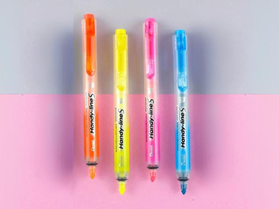 4 Pentel Handy-line S Retractable Chisel Tip Highlighters against grey and pink background