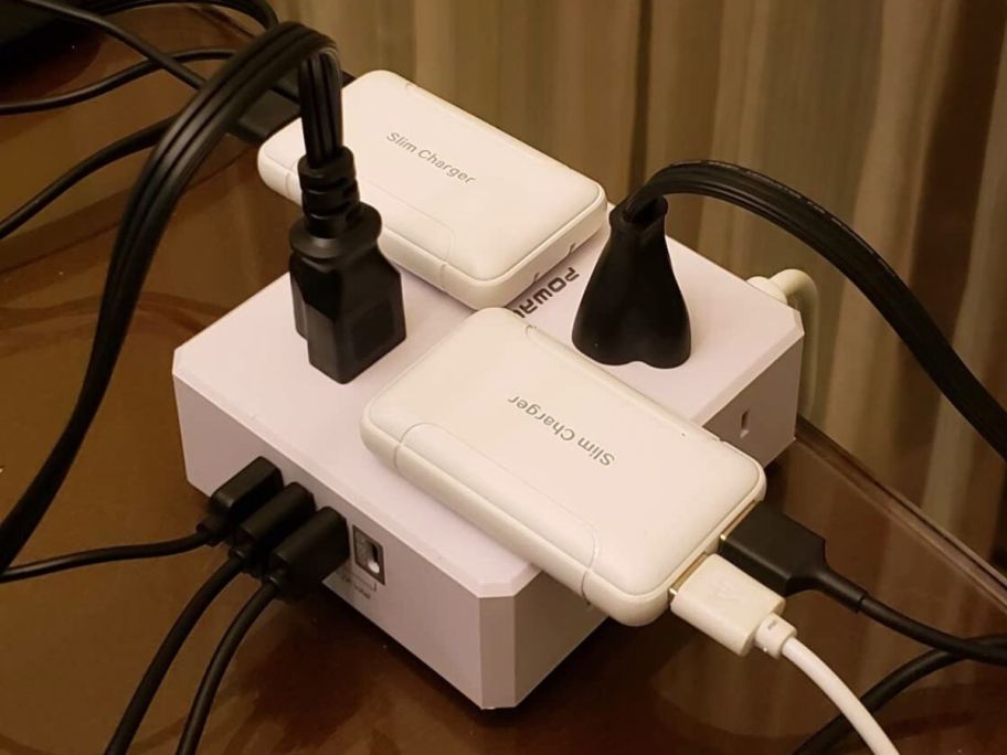 A Powerui Outlet Extender with many plugs plugged into it