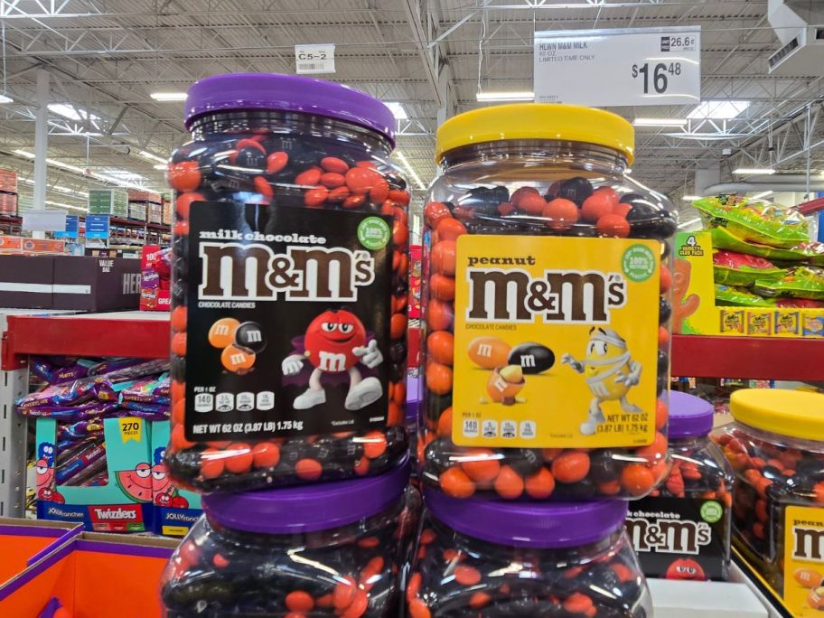 2 large tubs of M&M halloween candies in a store