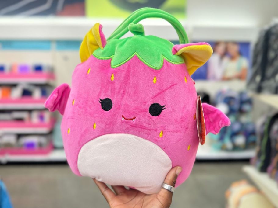 Squishmallows Gwendolyn the Neon Strawberry Bat Halloween Treat Pail in hand in store