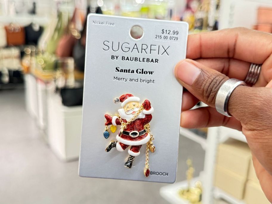 SugarFix by BaubleBar Santa Glow Brooch in hand in store