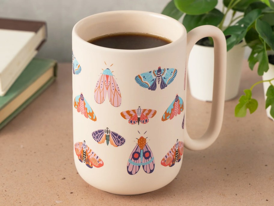 coffee mug covered in butterflies