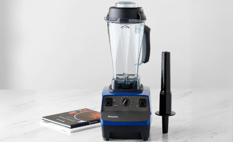 willow blue and black vitamix blender, tamper, and cookbook on counter