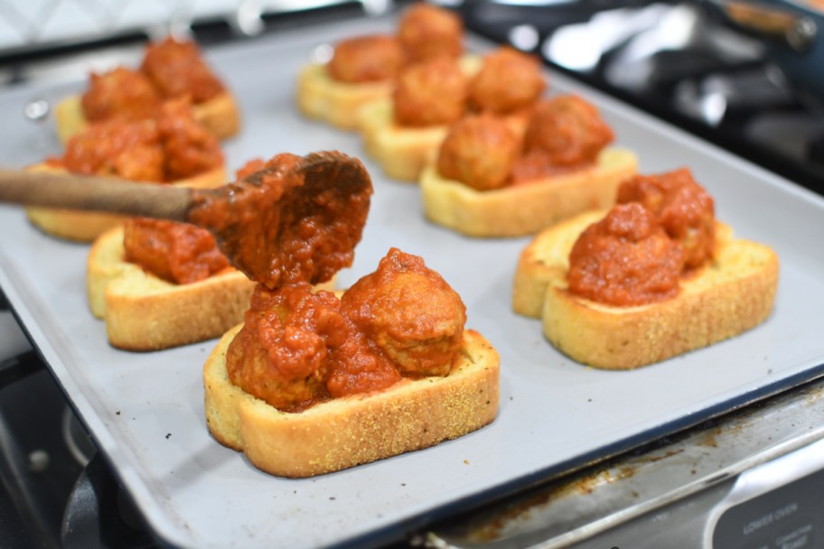 adding meatballs on top of texas toast