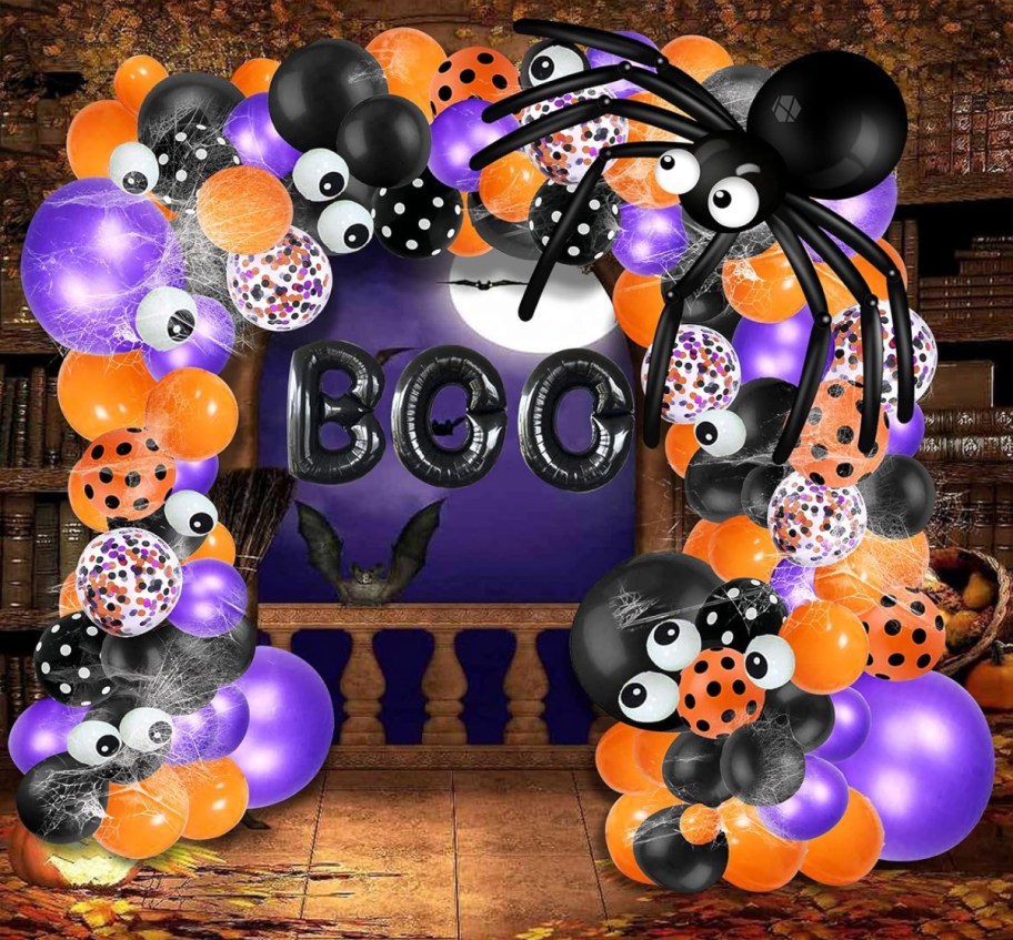 stock image of an assembled halloween balloon arch with orange, black, purple and white balloons