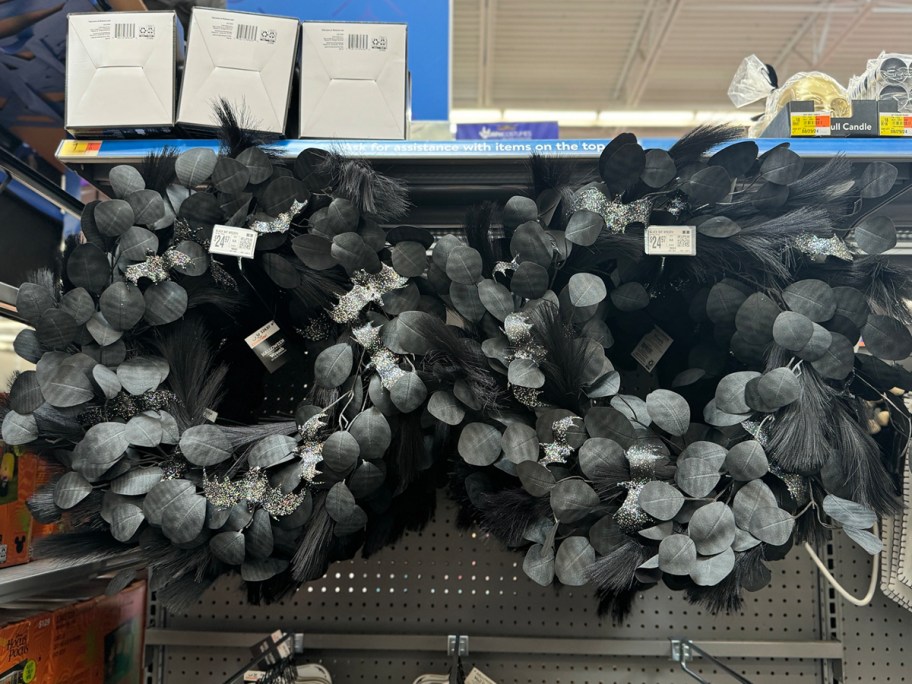 a black halloween wreath on a store shelf