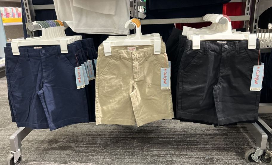 3 pair of cat and jack uniform shorts on a rack in a store