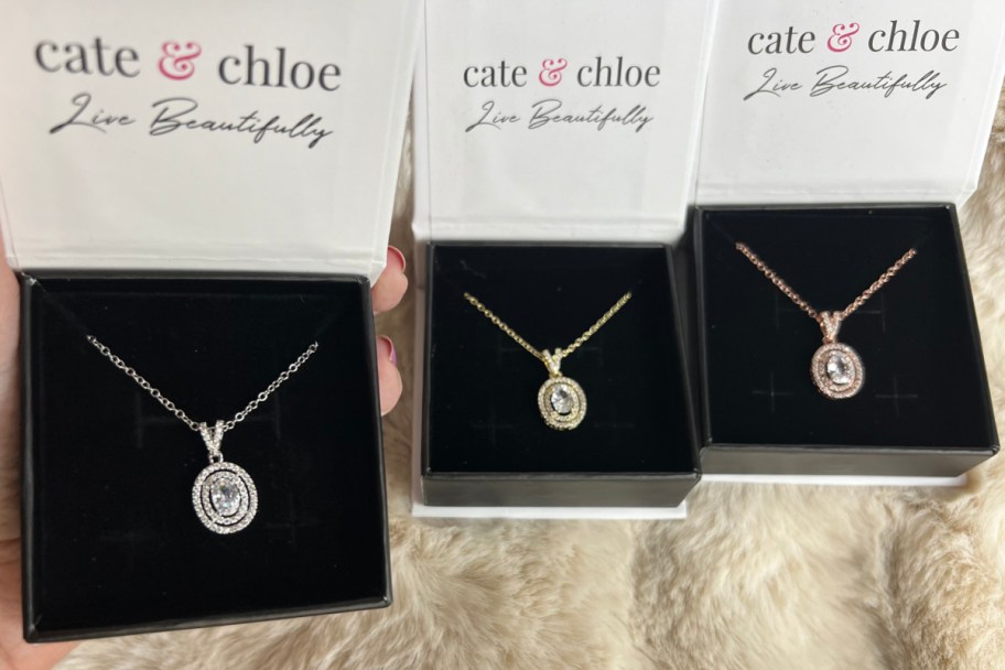 three oval necklaces in gift boxes