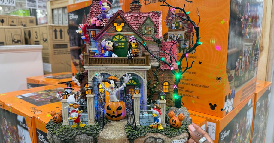 hand reaching for disney mickey halloween house 