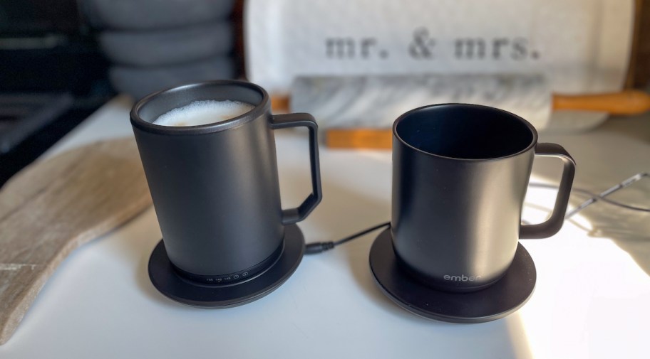 two dark gray self warming coffee mugs sitting on countertop