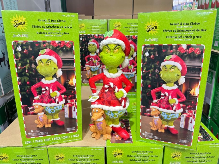 grinch with max holiday statue on display in a costco store