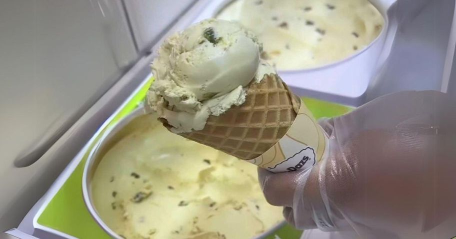 haagen dazs pistachio ice cream cone held by hand