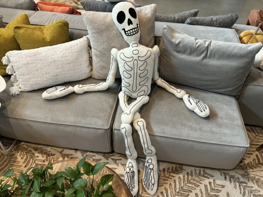 lifesize skeleton pillow displayed on the couch