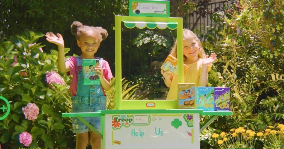 girls playing with girl scout booth outside