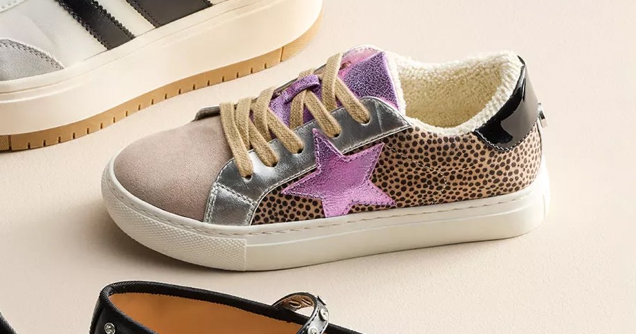 madden girl MZEZE Girls' Sneakers pictured on a neutral background with other madden shoes