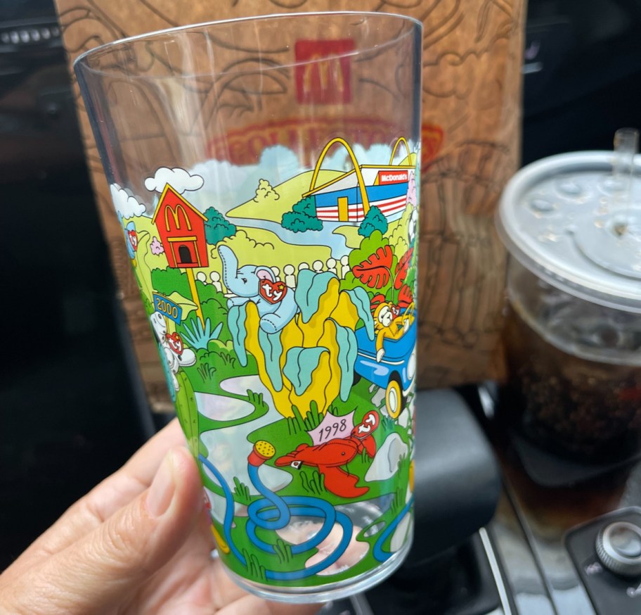 hand holding a mcdonalds cup with beanie babies designs