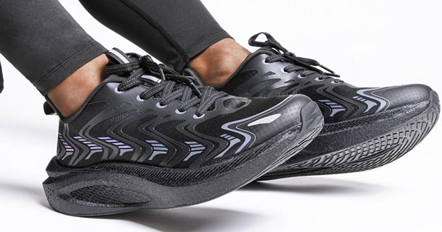 person wearing black athletic shoes 