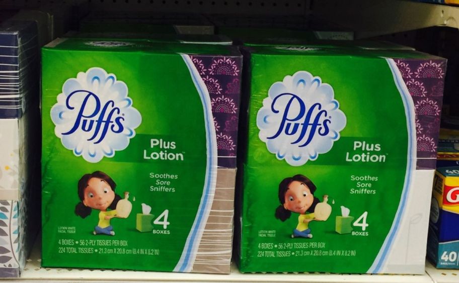 2 4-packs of puffs plus facial tissues on a store shelf