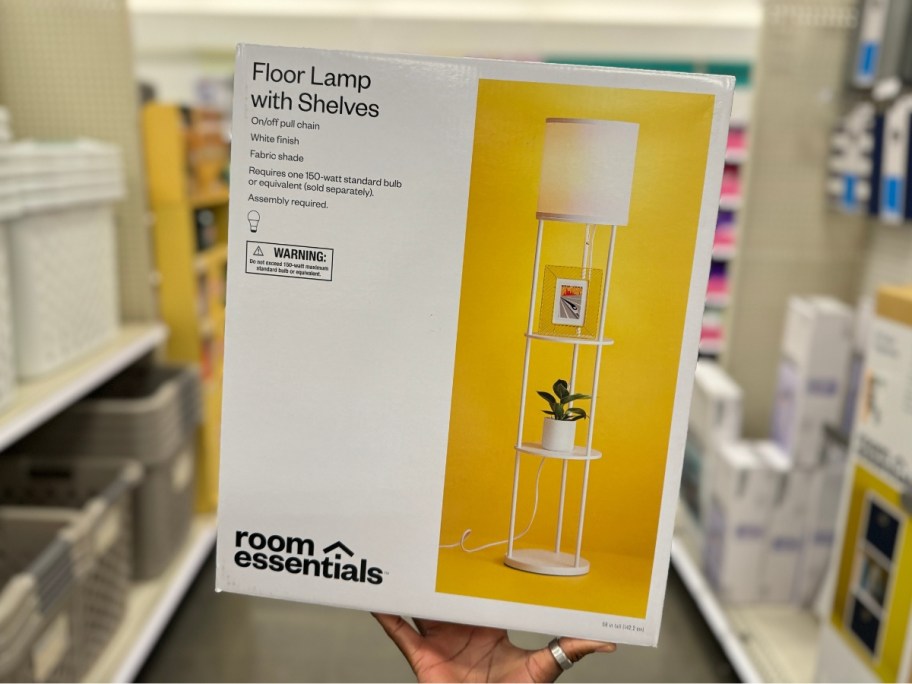 hand holding a box with a Room Essentials Shelf Floor Lamp in an aisle at Target