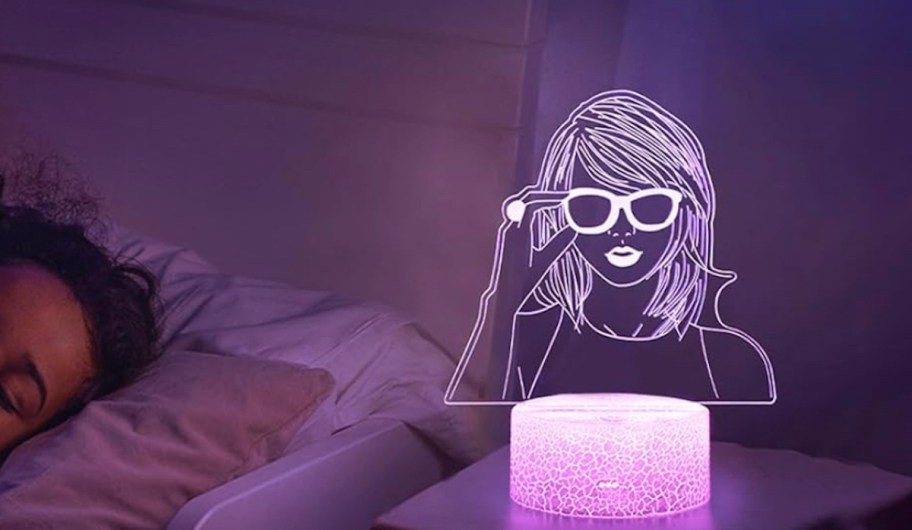 pink taylor swift night light on bedside table