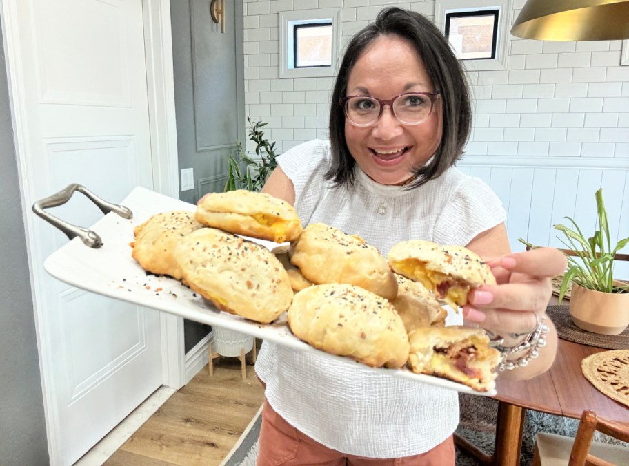 woman holding a tray of breakfast bombs 