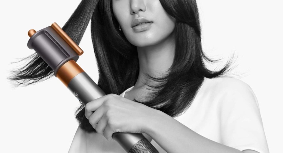 woman using dyson styler on her hair