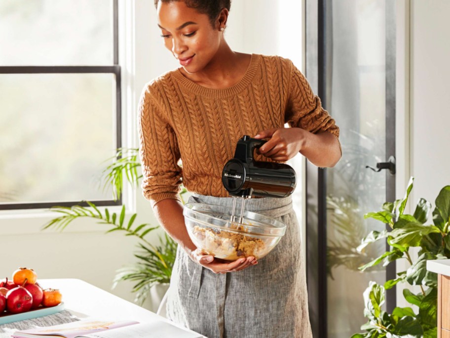 woman using wireless mixer with bowl