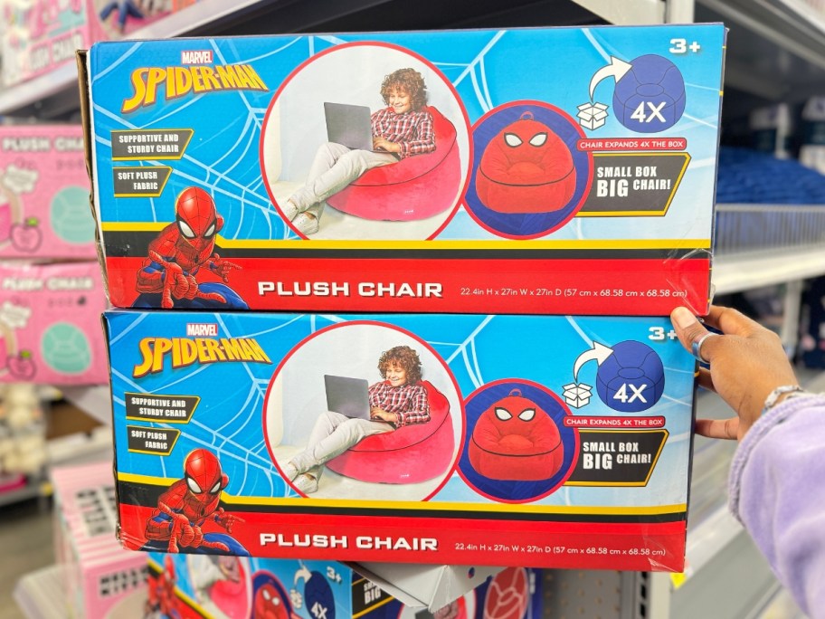 hand reaching for a red and blue box with a Spiderman Kids Plush Bean Bag Chair