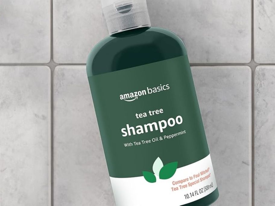 A bottle of Amazon Basics Tea Tree Shampoo