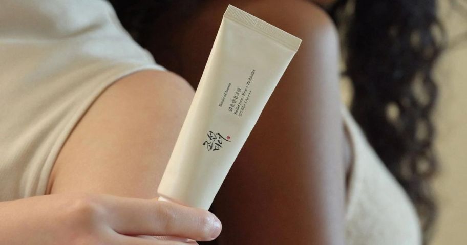 Hand holding a tube of Beauty of Joseon Relief Sun: Rice + Probiotics w/ SPF 50+ 