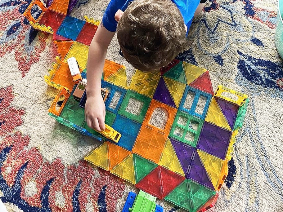 boy playing with colorful magnetic tiles set