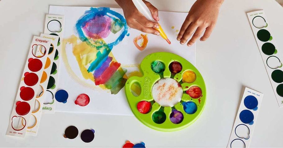 Someone painting a masterpiece with a Craolya palette of washable colors 