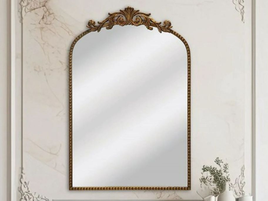 Crystal Art Gallery 20" x 30" Filigree Arch Wall Mirror on a marble wall
