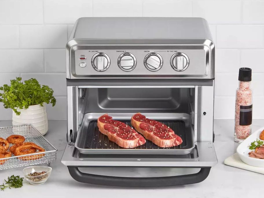 Toaster oven with airfryer and grill system with two pieces of steak opened to be seen