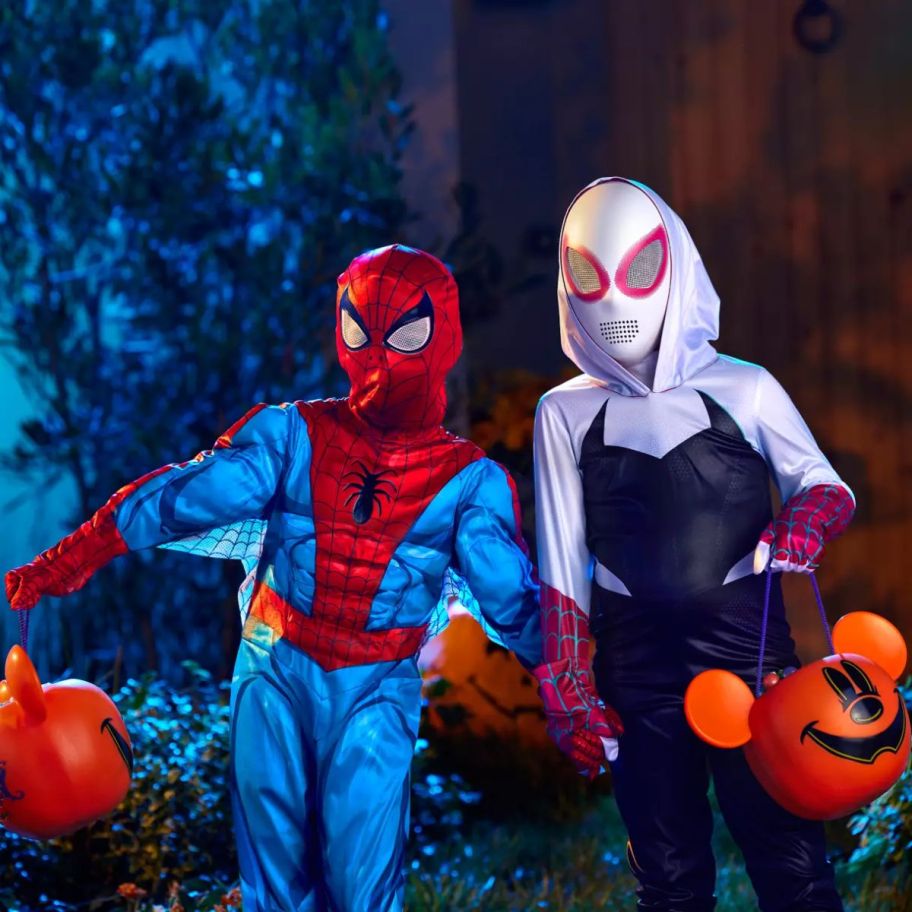 a little girl in a spide-gwen costume and a little boy in a spider-mancostume