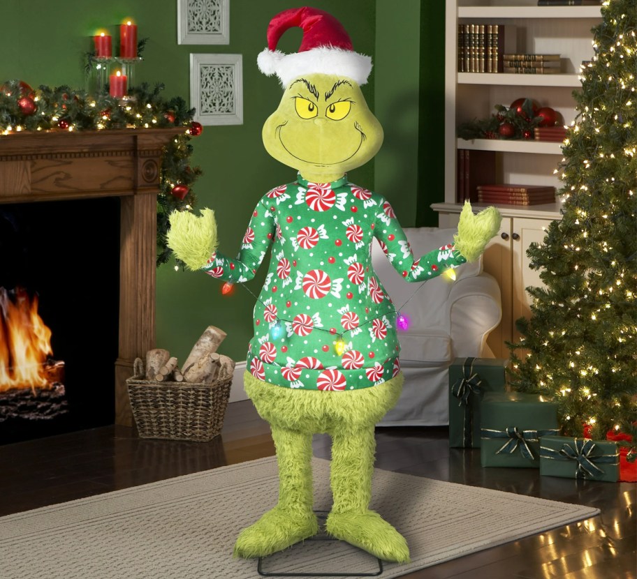 life-sized grinch decoration standing in living room